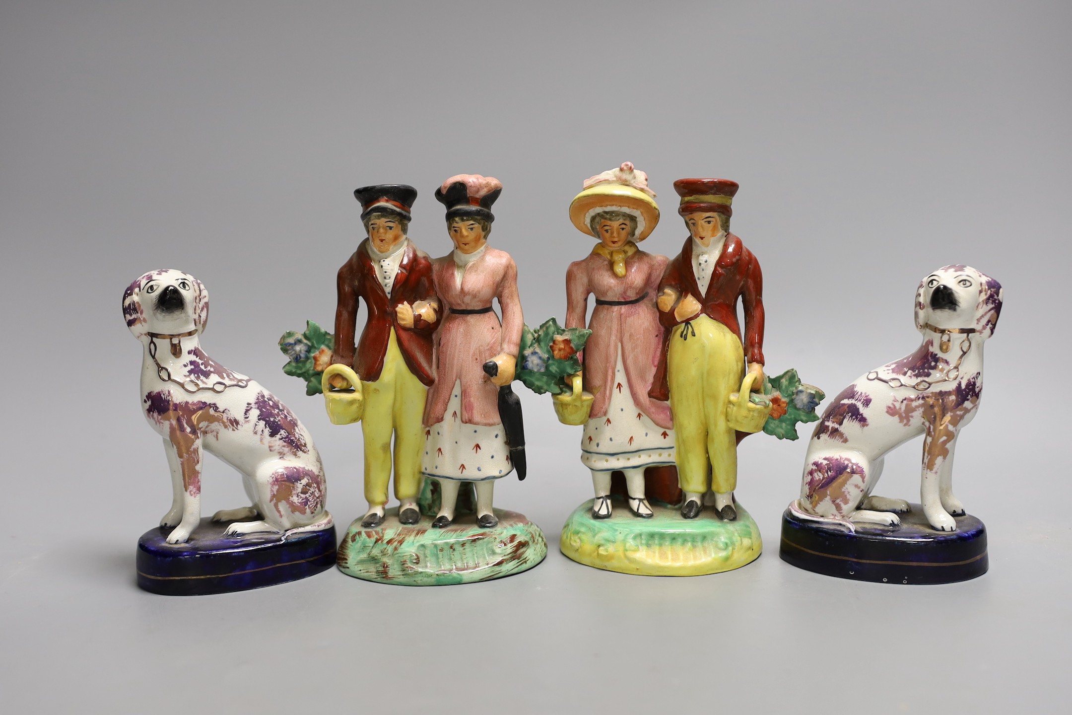 A pair of Staffordshire pink lustre spaniels and a pair of similar groups of a dandy and dandizette , 16.5cm